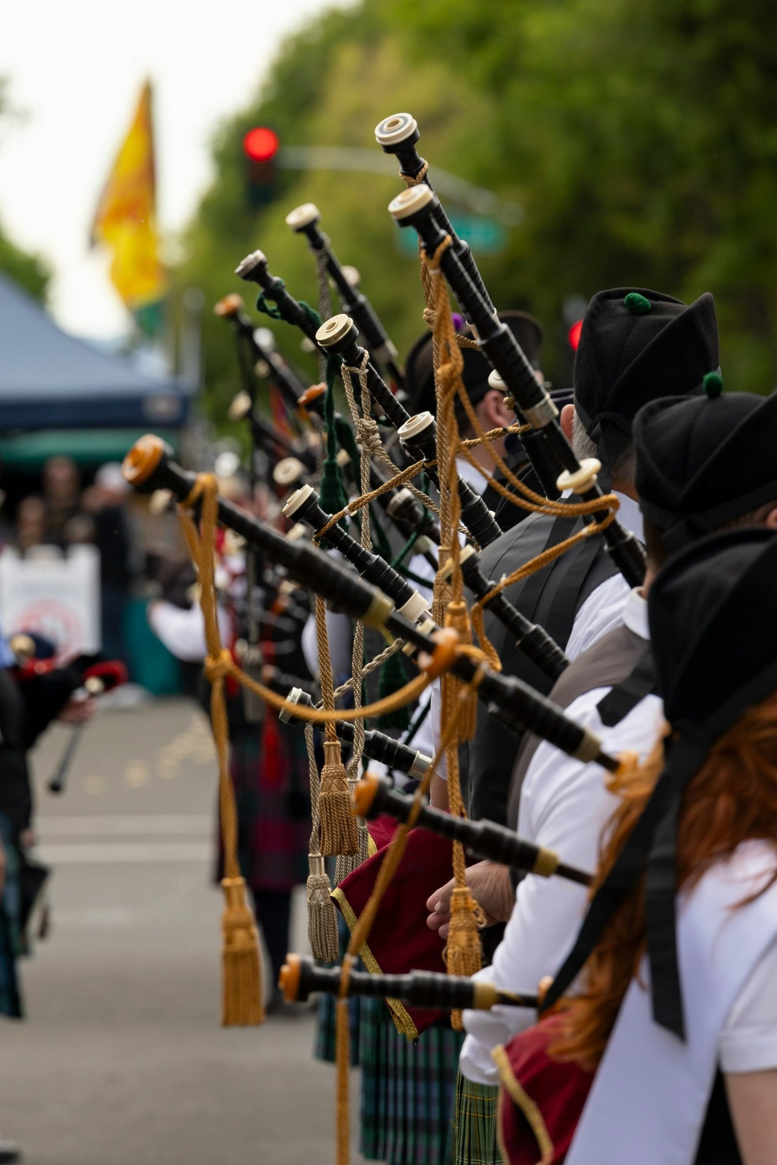 A group of pipers in formation, kilted and playing in unison
